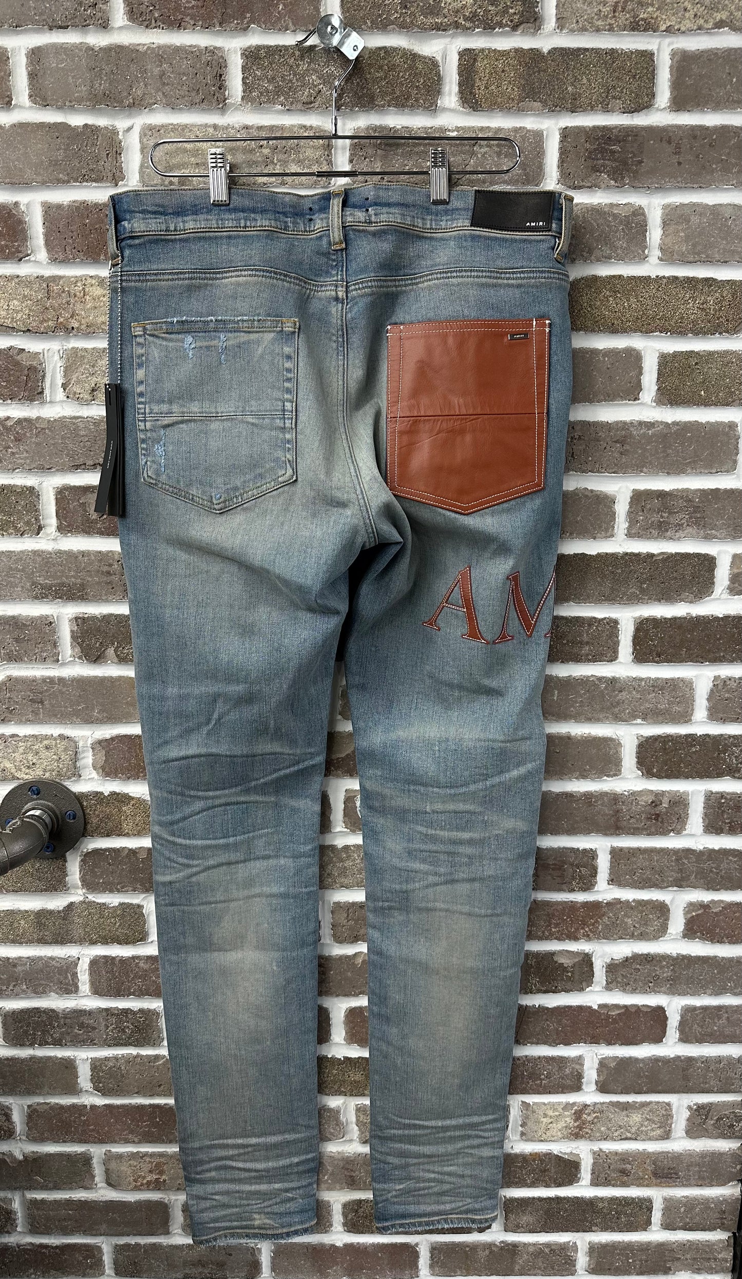 Amiri MX1 Brown Logo Patch Jeans