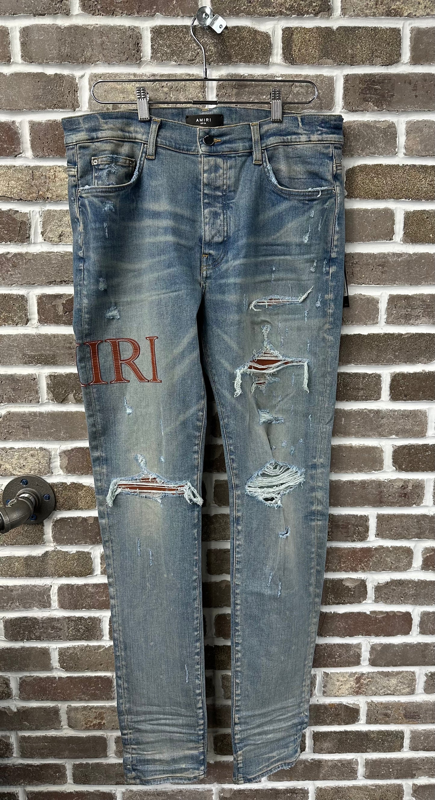 Amiri MX1 Brown Logo Patch Jeans