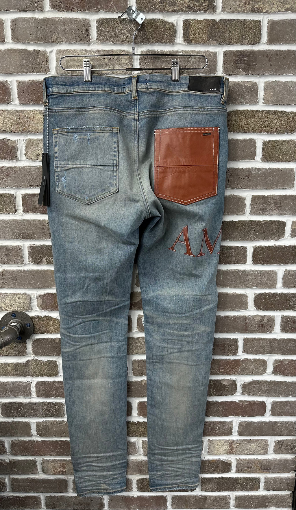 Amiri MX1 Brown Logo Patch Jeans