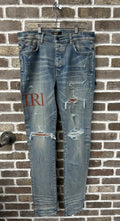 Amiri MX1 Brown Logo Patch Jeans